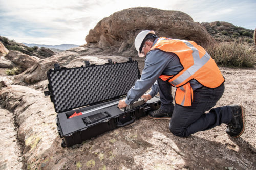 Worker handling equipment in a peli case